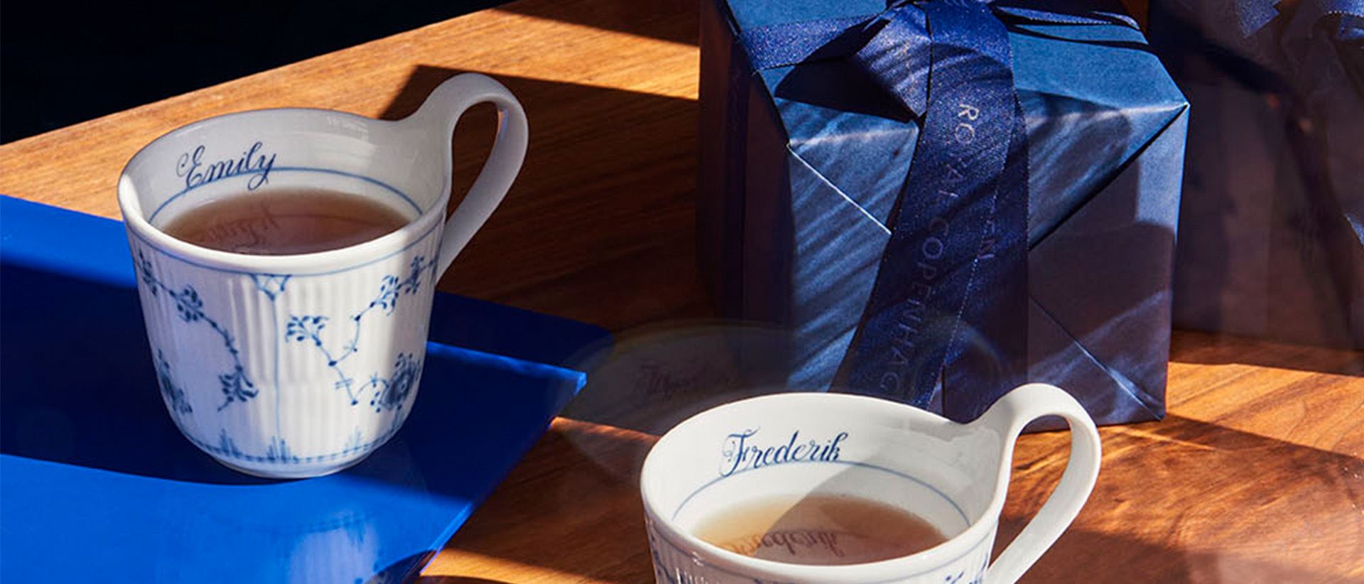Two cups from Bespoke on a table with a gift from Royal Copenhagen