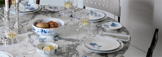 Dinner table set with blomst plates and bowls