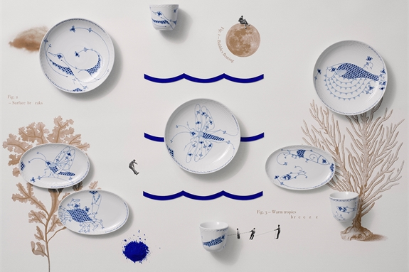Royal Creatures plates and mugs lying on a table with drawings of inspirations from the ocean and the three blue waves